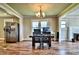 Dining room with wooden table and chairs, bright windows, and view of the fireplace at 302 Griffith Rd, Monroe, NC 28112