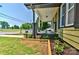 Inviting front porch with stone columns, complemented by well-maintained landscaping and manicured lawn at 302 Griffith Rd, Monroe, NC 28112