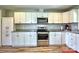 Kitchen showcases white cabinetry, stainless steel appliances, and granite counters at 302 Griffith Rd, Monroe, NC 28112