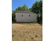 Side view of a house with a backyard surrounded by a black metal fence at 3204 Leah Elizabeth Ln, Monroe, NC 28110