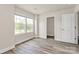 Bright bedroom featuring light wood-look floors, walk-in closet, and natural light from double windows at 3204 Leah Elizabeth Ln, Monroe, NC 28110