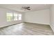 Large bonus room featuring light wood-look floors, ceiling fan, and many windows for ample natural light at 3204 Leah Elizabeth Ln, Monroe, NC 28110
