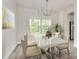 Bright dining room with marble table, modern chandelier, and a large window offering scenic views at 3204 Leah Elizabeth Ln, Monroe, NC 28110