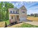 Attractive two-story home with a brick-accented porch and a two-car garage at 3204 Leah Elizabeth Ln, Monroe, NC 28110