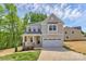 Charming two-story home featuring a covered porch, attached two-car garage, and professionally landscaped yard at 3204 Leah Elizabeth Ln, Monroe, NC 28110