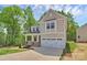 Charming two-story home featuring a covered porch, attached two-car garage, and professionally landscaped yard at 3204 Leah Elizabeth Ln, Monroe, NC 28110