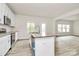 Bright kitchen featuring stainless steel appliances, a granite island and white cabinets at 3204 Leah Elizabeth Ln, Monroe, NC 28110