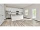 Bright kitchen featuring stainless steel appliances, a granite island and white cabinets at 3204 Leah Elizabeth Ln, Monroe, NC 28110
