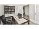 This office features built-in bookshelves, a spacious desk and a stylish chair, perfect for working from home at 3204 Leah Elizabeth Ln, Monroe, NC 28110