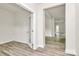 An empty room with light colored laminate flooring, neutral walls and white trim, with an open doorway at 3204 Leah Elizabeth Ln, Monroe, NC 28110