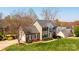 Aerial view of a two-story home with lush landscaping, a large yard, and an attached garage at 3765 11Th Ne St, Hickory, NC 28601