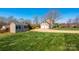 Expansive backyard with a well-maintained lawn, a storage shed, and a spacious driveway leading to the garage at 3765 11Th Ne St, Hickory, NC 28601