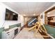 Finished basement with a cozy seating area, playful wooden play structure, and stylish wood-look flooring at 3765 11Th Ne St, Hickory, NC 28601