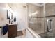Bathroom showcasing a walk-in shower with a glass door, vanity, and neutral tile at 3765 11Th Ne St, Hickory, NC 28601