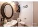 Stylish half bathroom with a decorative mirror, pedestal sink, and modern fixtures and decor at 3765 11Th Ne St, Hickory, NC 28601