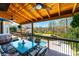 Inviting covered deck features a dining table, ceiling fans, and a lovely backyard view with an inground pool at 3765 11Th Ne St, Hickory, NC 28601