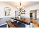 Inviting dining room with rustic wooden table, bench seating, modern chandelier, and decorative mirror at 3765 11Th Ne St, Hickory, NC 28601