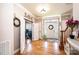 Welcoming foyer with hardwood floors, decorative wreaths, a staircase, and a view into an office at 3765 11Th Ne St, Hickory, NC 28601