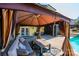 Stylish gazebo beside pool with seating, offering a comfortable outdoor living space for relaxation and entertaining at 3765 11Th Ne St, Hickory, NC 28601
