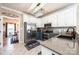 Well-lit kitchen featuring white cabinetry, stainless steel appliances, mosaic tile backsplash, and granite countertops at 3765 11Th Ne St, Hickory, NC 28601