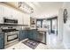 Bright kitchen with stainless steel appliances, two-tone cabinets, mosaic backsplash, and a kitchen island at 3765 11Th Ne St, Hickory, NC 28601