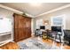 Cozy office space featuring hardwood floors, a large wooden armoire, and ample natural light at 3765 11Th Ne St, Hickory, NC 28601