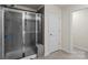 Modern bathroom featuring a glass shower with gray tile and a view into another room at 4104 Armstrong Farm Dr, Belmont, NC 28012