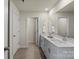 Bright bathroom featuring a large mirror, a double sink vanity, and tile flooring at 4104 Armstrong Farm Dr, Belmont, NC 28012