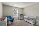 Bright Bedroom with a white crib, accent chair, carpet, and natural light from a window at 4104 Armstrong Farm Dr, Belmont, NC 28012