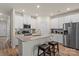 Modern kitchen boasts stainless steel appliances, an island with bar stools, and ample cabinet space at 4104 Armstrong Farm Dr, Belmont, NC 28012