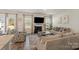 Cozy living room boasts a fireplace, hardwood floors, large windows, and comfortable seating at 4104 Armstrong Farm Dr, Belmont, NC 28012