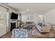 Cozy living room boasts a fireplace, hardwood floors, large windows, and comfortable seating at 4104 Armstrong Farm Dr, Belmont, NC 28012