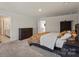 Large primary bedroom featuring plush carpet, neutral tones, and ensuite bathroom access at 4104 Armstrong Farm Dr, Belmont, NC 28012