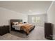 Serene main bedroom with a comfortable bed, carpet flooring, and natural light from the windows at 4104 Armstrong Farm Dr, Belmont, NC 28012