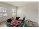 Brightly lit room with hardwood flooring, two windows and containing a number of toys and baby accessories at 4104 Armstrong Farm Dr, Belmont, NC 28012