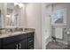 This bright bathroom features granite counters, modern vanity, and natural light from the nearby shower and window at 4210 Holly Ne Cir, Conover, NC 28613