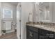 This bathroom features a modern vanity with granite counters, and ample natural light from the nearby window at 4210 Holly Ne Cir, Conover, NC 28613