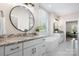 This bright bathroom offers granite counters, dual vanities, a modern tub, and a serene atmosphere at 4210 Holly Ne Cir, Conover, NC 28613