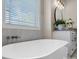 This bright bathroom boasts a sleek, modern bathtub and a sun-filled window for a relaxing experience at 4210 Holly Ne Cir, Conover, NC 28613