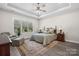 This bedroom features natural light, a ceiling fan, and ample space for relaxing and unwinding at 4210 Holly Ne Cir, Conover, NC 28613