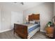 Bedroom featuring a traditional style bed frame, ceiling fan, and a set of double doors at 4210 Holly Ne Cir, Conover, NC 28613