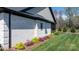 Close-up of the exterior with brick siding and landscaping including green, yellow, and purple plants at 4210 Holly Ne Cir, Conover, NC 28613