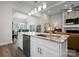 Kitchen with white island and granite countertops overlooking living and dining spaces; ideal for entertaining at 4210 Holly Ne Cir, Conover, NC 28613