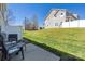 Backyard view of a grassy lawn, white fence, and patio furniture at 4644 Craigmoss Ln, Charlotte, NC 28278
