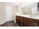 Bathroom featuring a double vanity, spacious mirror, and a tiled floor at 4644 Craigmoss Ln, Charlotte, NC 28278
