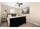 Bedroom featuring a bed, ceiling fan, large window, and art at 4644 Craigmoss Ln, Charlotte, NC 28278