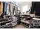 Walk-in closet offering ample storage with shelves and rods for clothing, shoes, and accessories at 4644 Craigmoss Ln, Charlotte, NC 28278