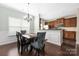 Open dining area with bright walls and a modern chandelier at 4644 Craigmoss Ln, Charlotte, NC 28278