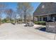 Exterior view of a community clubhouse with stone picnic tables and fire pit at 4644 Craigmoss Ln, Charlotte, NC 28278