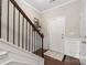 Inviting foyer with wood flooring, staircase with decorative railing, and neutral paint at 4644 Craigmoss Ln, Charlotte, NC 28278